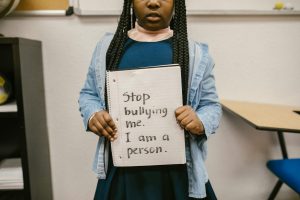 African American girl with empowering anti-bullying message in school setting.