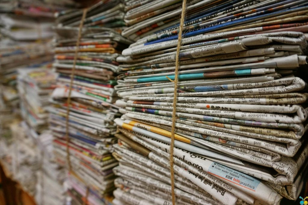 Close-up view of stacked newspapers tied with twine, ideal for recycling and storage concepts.