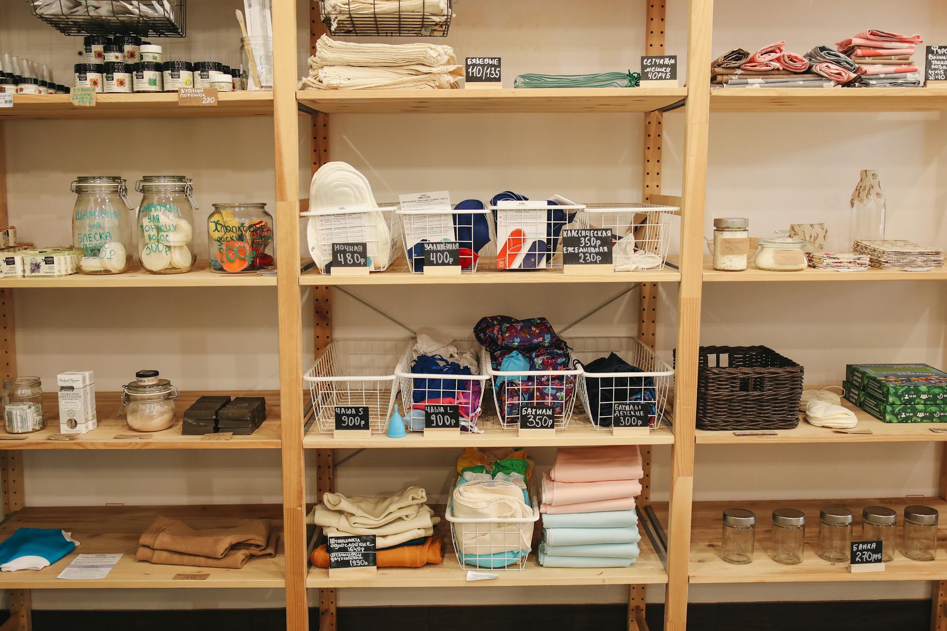 Wooden shelves displaying eco-friendly, reusable products in a zero-waste store.