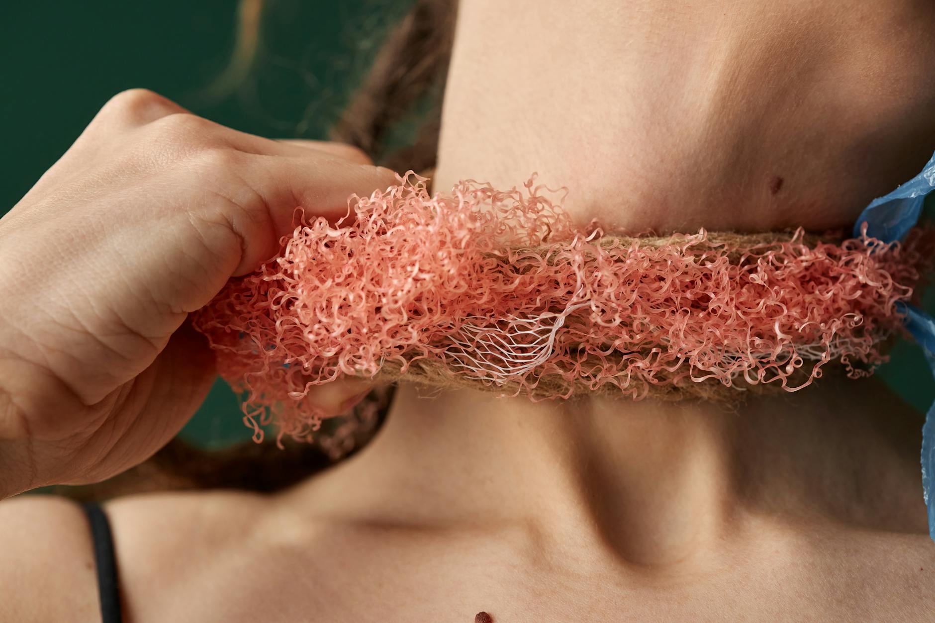 Close-up of a woman's neck with a plastic item, highlighting pollution's health impact.