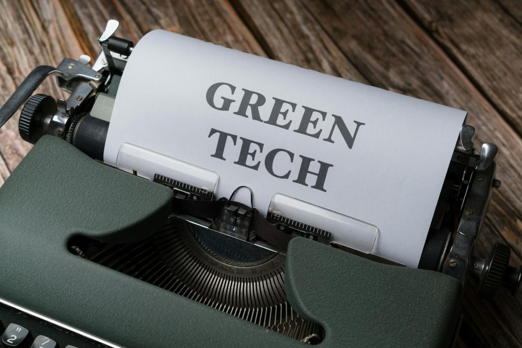 A top view of a vintage typewriter with 'Green Tech' typed on paper, symbolizing sustainable technology.