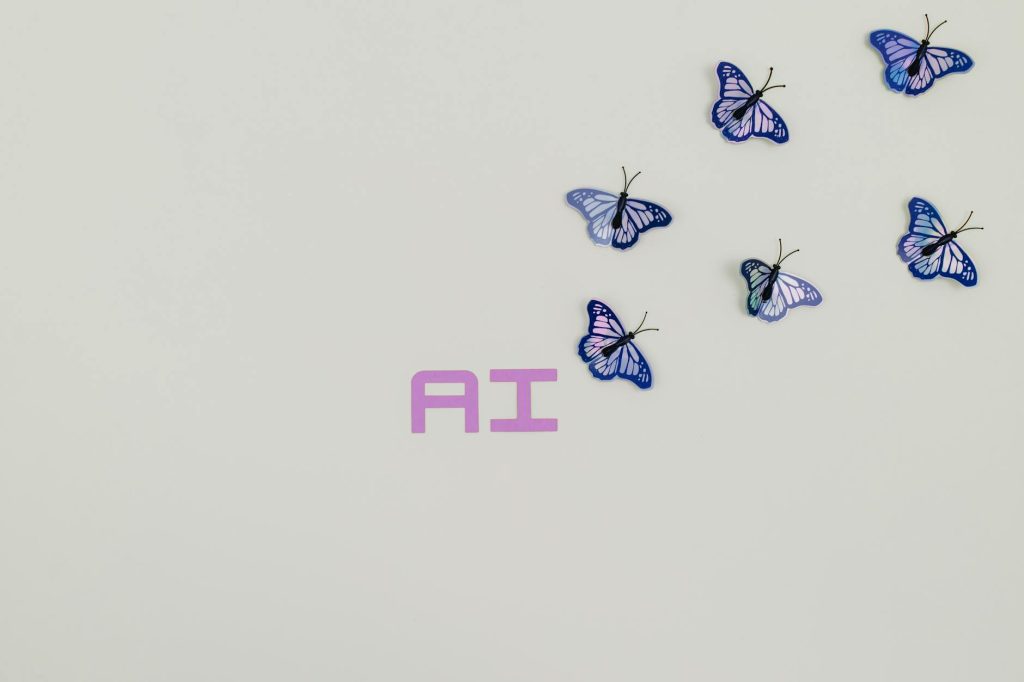 A creative image of butterflies flying over the word 'AI' on a soft pastel background, symbolizing innovation.