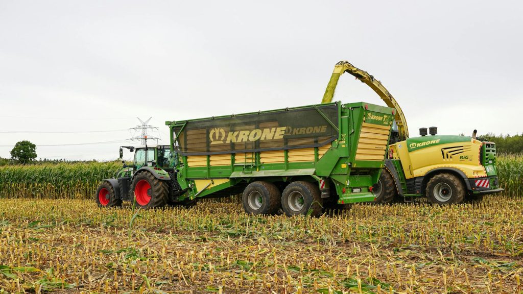 Autumn corn harvest with tractors in Lütau, Schleswig-Holstein, showcasing modern farming techniques.