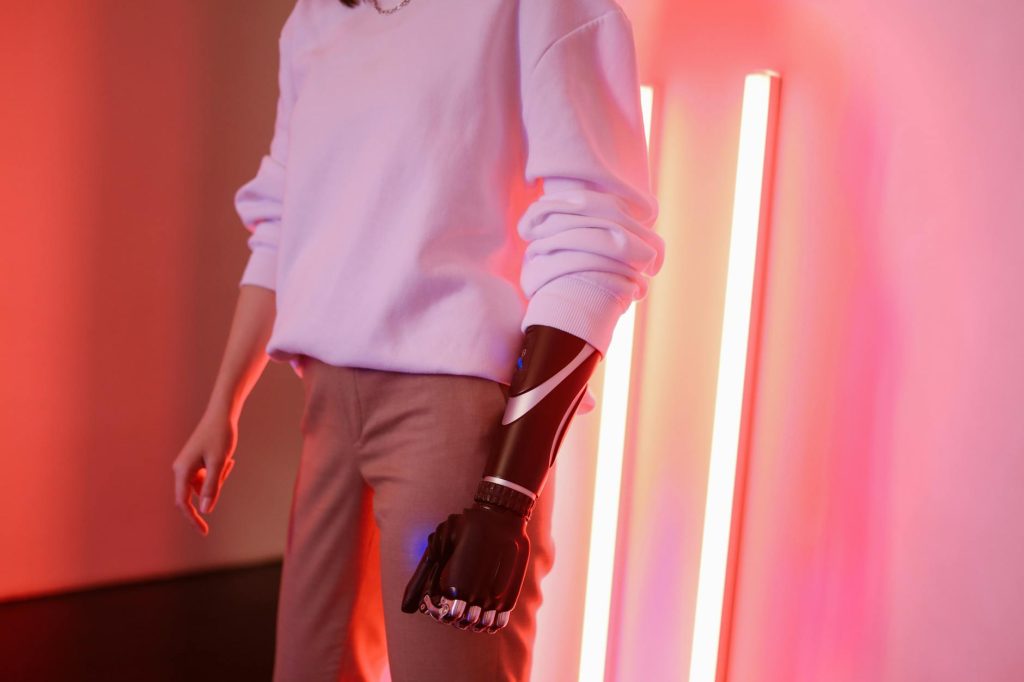 Portrait of a woman with a sleek prosthetic arm, showcasing modern technology.
